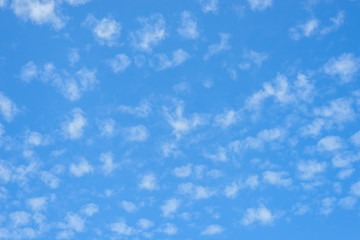 many little white clouds in summer blue sky