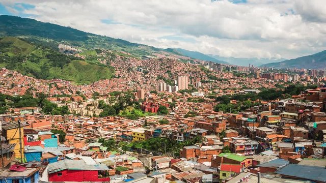Medellin, Colombia, time lapse view over the famous Comuna 13 slums during daytime. Zoom out.
