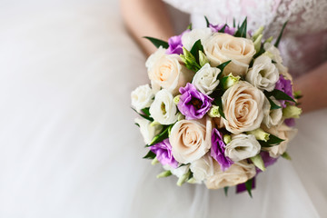 purple bouquet in the hands of the bride. Closeup