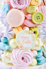 Easter dessert for children: colorful candy treats with cookies and meringue. Happy Easter.
