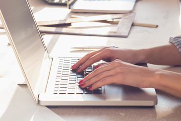 Architect working on a laptop in the sunny office.