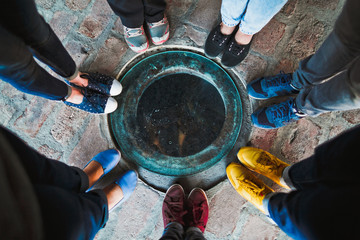 Top view of a group of seven girlfriends in multi-colored shoes.
