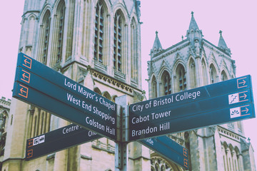 Bristol Tourist Signpost, West Facade Towers of Bristol Cathedral in background, split toning shallow depth of field horizontal photography - 197157851
