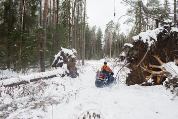 Proffesional Lumberjack hold hand saw. Winter wearing protection clothes using chainsaw. clean fallen trees