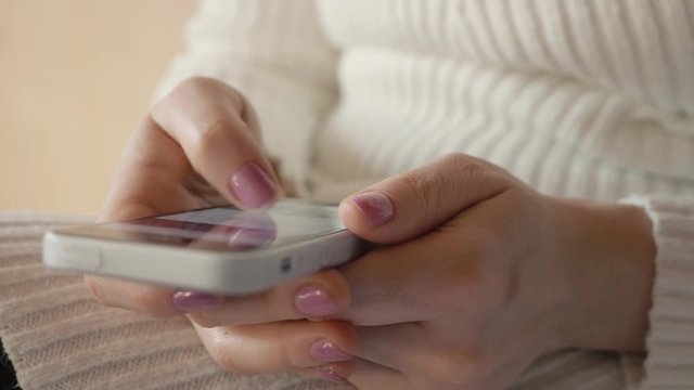 the girl holding the smartphone dials the number on the screen.