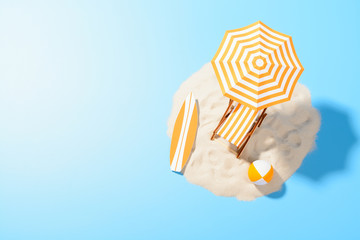 Obraz premium Tropical vacation background. Sun lounger with umbrella and beach accessories for active rest on the sandy island, copy space, top view