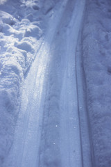 rolled trails in the winter forest in the snow, in the evening. Russia.