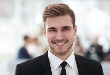 portrait of confident young businessman on blurred background.