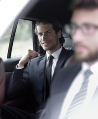 businessman sitting in his car.