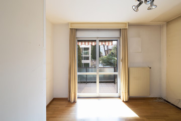 White empty room with window and parquet