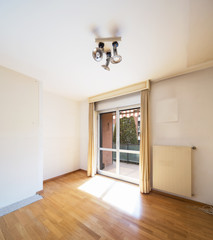 White empty room with window and parquet