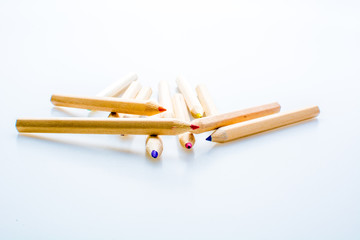 Wooden color pencils isolated on a white background. Concept of knowledge and education