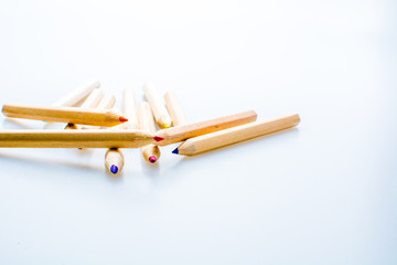 Wooden color pencils isolated on a white background. Concept of knowledge and education