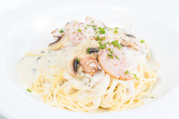 Spaghetti turkey Carbonara with button mushroom close up