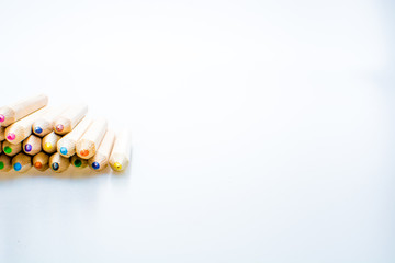 Wooden color pencils isolated on a white background. Concept of knowledge and education