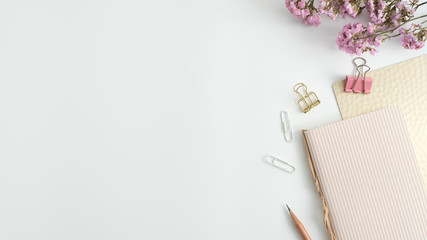 Styled stock photography white office desk table with blank notebook, keyboard, macaroon, supplies and coffee cup. Top view with copy space. Flat lay.