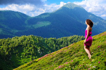 Naklejka premium The girl enjoys landscapes in the mountains of the Carpathians.