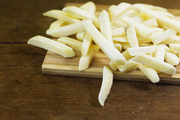 Freeze potato stick on wooden cutting board 