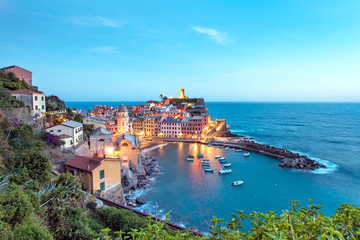 Naklejka na ściany i meble Magical landscape with boats in the bay and colored houses on the rock in Vernazza, Cinque Terre, Italy, Europe