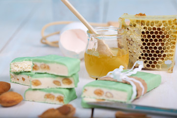 Honey in the glass close to the honeycomb.