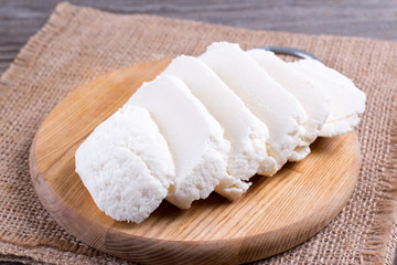Slices of mozzarella on a cutting board. Italian pizza