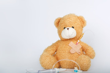 Teddy bear with blood transfusion system. Closeup