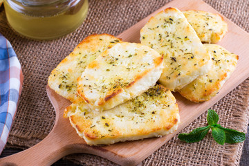 Grilled haloumi cheese with herbs on a cutting board