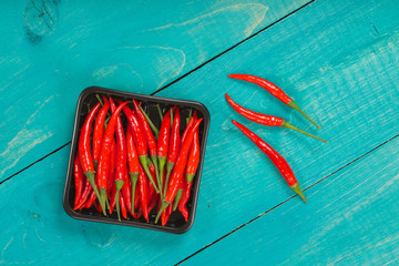 Fresh hot chili pepper on a wooden surface.