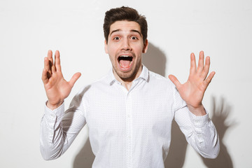 Fototapeta premium Portrait of a surprised young man dressed in shirt