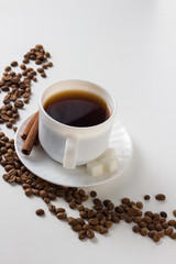 White Cup with Coffee, Coffee Beans on a White Background