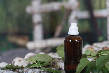 Glass of bottle of birch syrup.