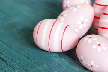 Fototapeta na wymiar Pink easter eggs on blue wooden background