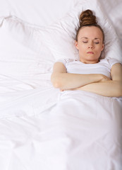 Young lady stays in her bed. Closeup