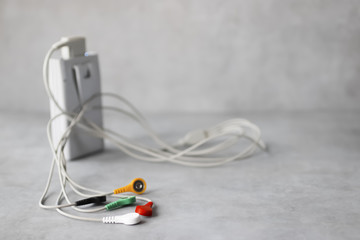 Holter monitoring device on gray background.