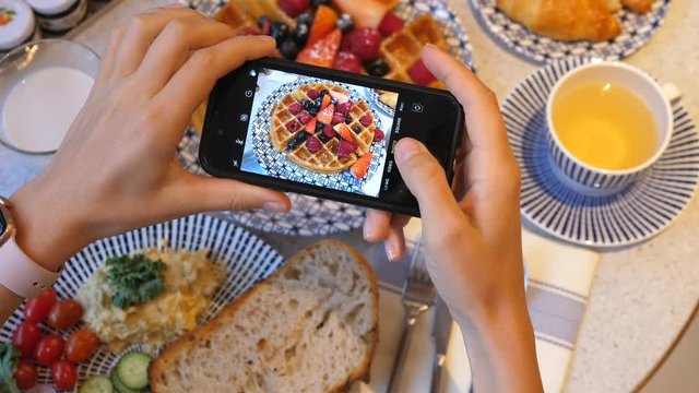 Woman Taking Photos Of Belgian Waffles For Breakfast With Smartphone