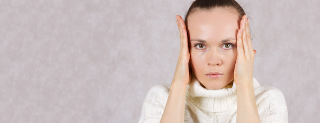 Young caucasian lady between 30 and 40 years uses her palms as blinders