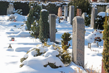 graveyard on a sunny winter day with snow