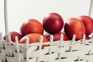 close-up view of traditional painted easter eggs in basket on grey