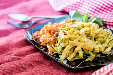Pasta with pesto sauce and Shrimp on a the table