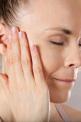 Ear of a young caucasian lady. Closeup