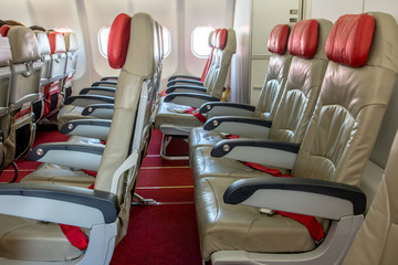 Airplane board with empty seats. Rows of seats in a flying plane without people.