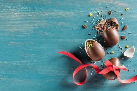 Top View Of Broken Chocolate Easter Eggs On Turquoise Surface