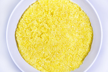 Healthy corn porridge on a white table. Easy food photo