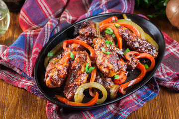 Chinese chicken wings with vegetables in sweet and sour sauce