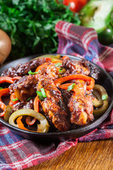 Chinese chicken wings with vegetables in sweet and sour sauce