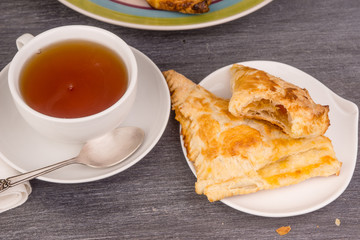 Delicious golden sweet triangles of puff pastry close-up
