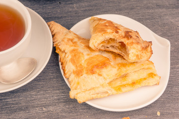 Delicious golden sweet triangles of puff pastry close-up