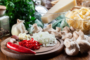 Ingredients ready for prepare tagliatelle pasta with champignon