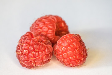 Macro photo of raspberries fruit. Rich in vitamins, antioxidants, and fiber, raspberries are a delicious fruit with many health benefits. 