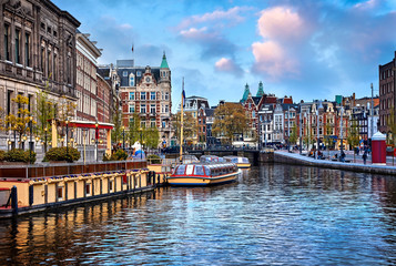 Channel in Amsterdam Netherlands houses river Amstel landmark - obrazy, fototapety, plakaty